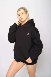 Side view of a warm, lined black gym hoodie for workouts