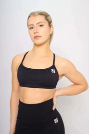 Black sports bra with cross-back design, front view