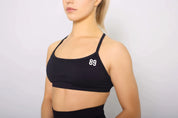 Black Sports bra for yoga, side view, medium support