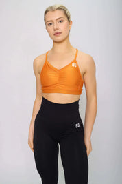 Burnt orange sports bra with strappy back, front view