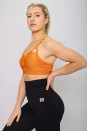 Burnt orange sports bra with light support, side view