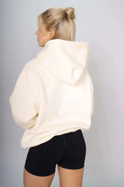 Back view of a women’s pullover hoodie in cream