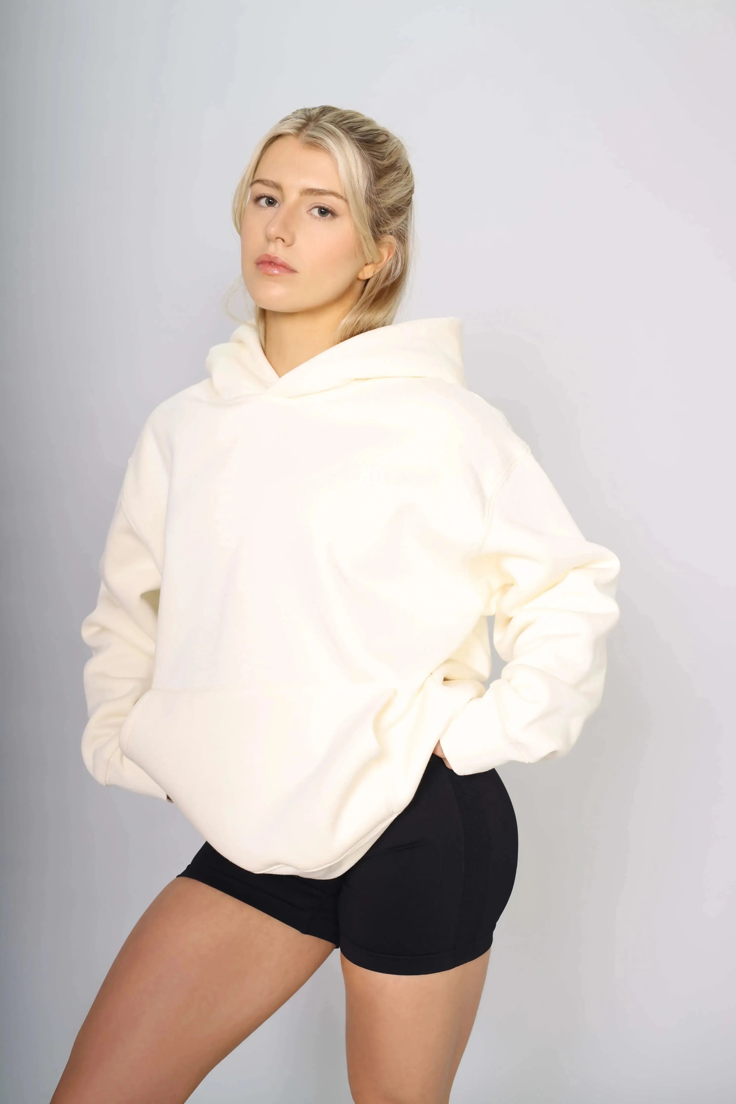 Side view of a heavy cream gym hoodie for workouts and casual wear