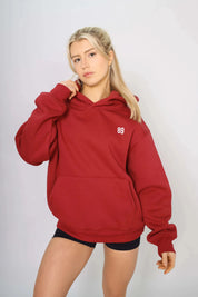 Front view of a red gym hoodie for women with a soft lined interior