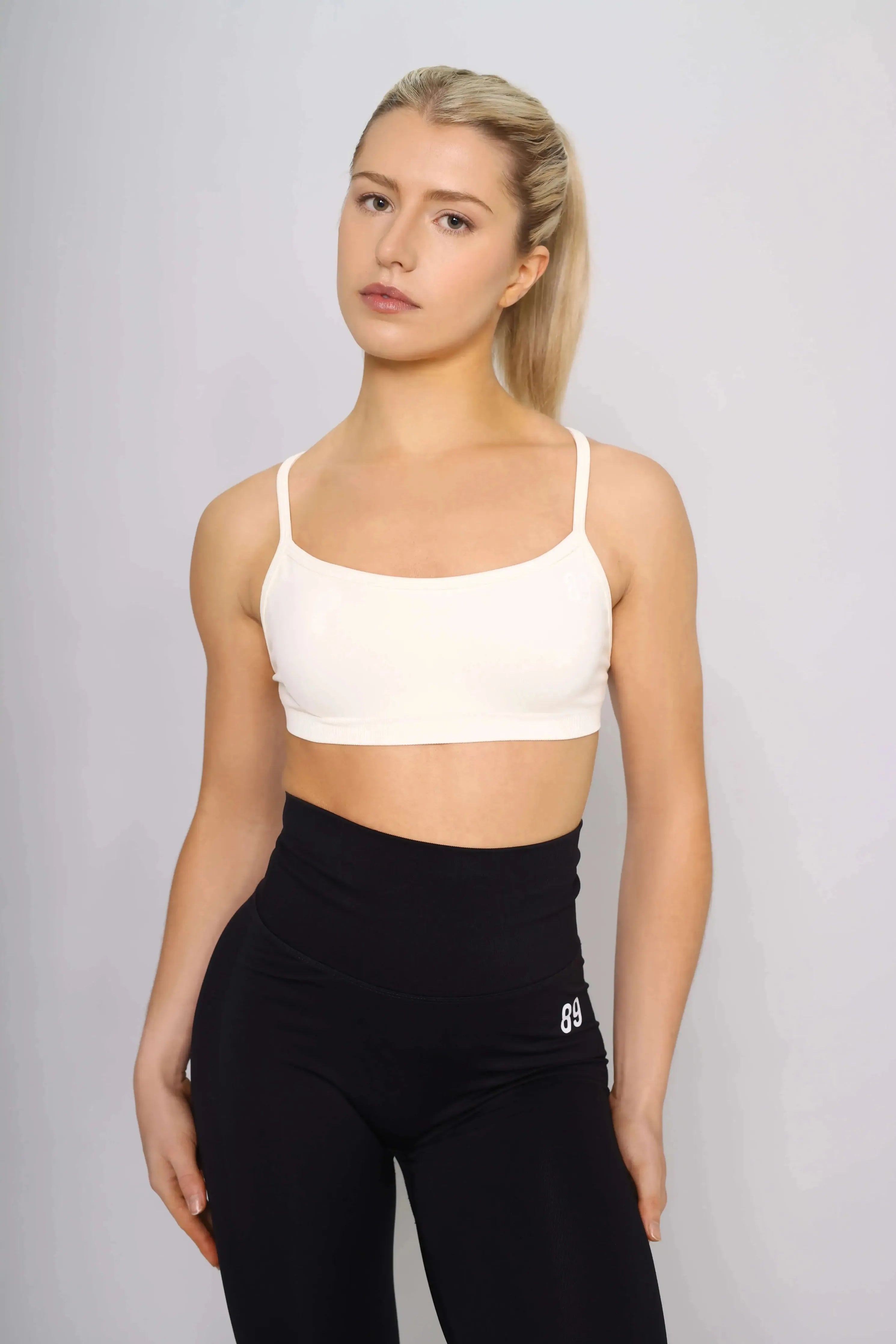 Off white sports bra designed for running, front view