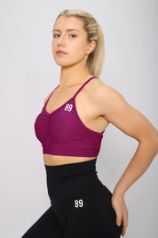 Sports bra in raspberry, side view