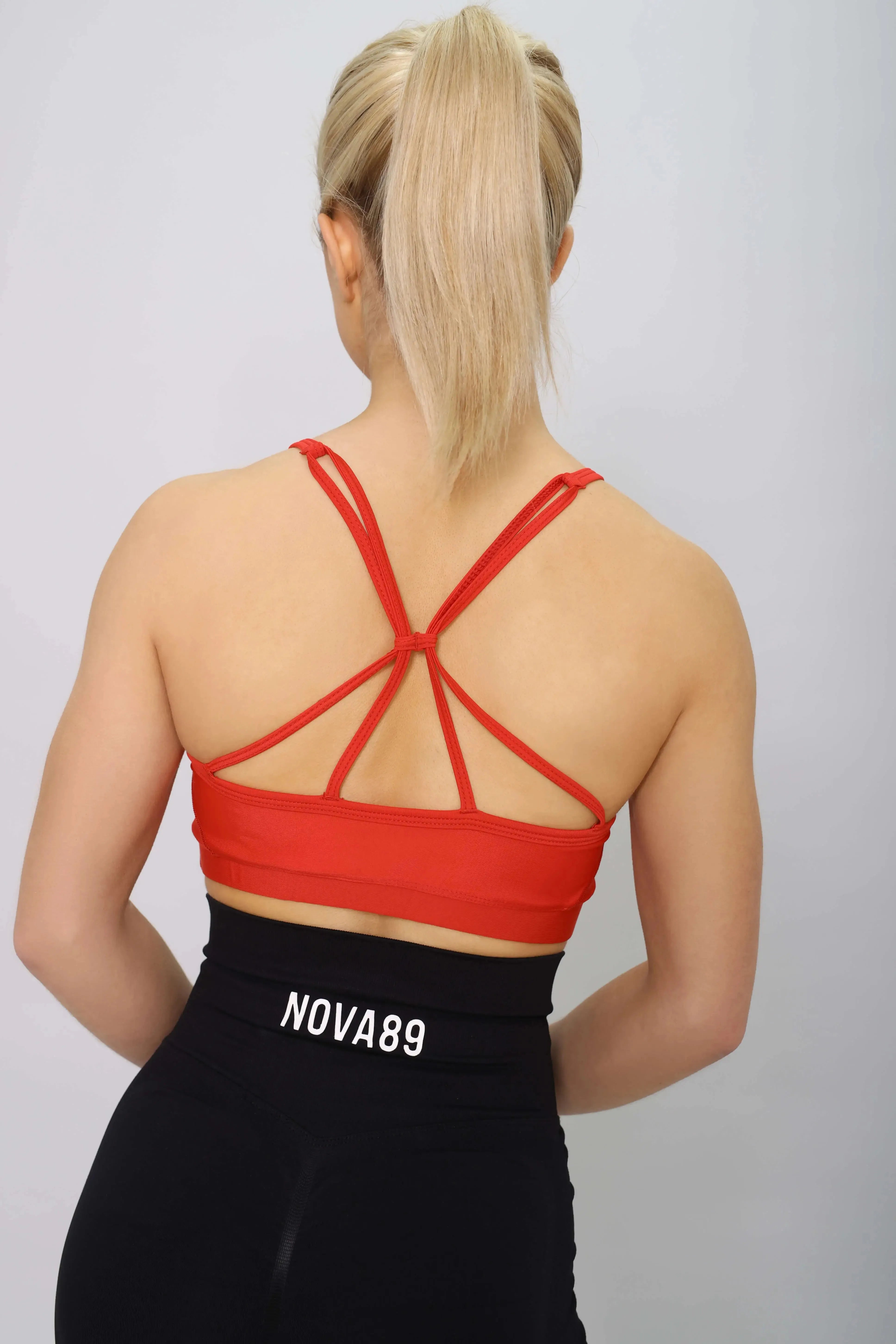 Red sports bra with light support, back view