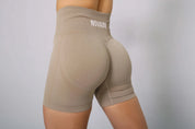 Bum scrunch gym shorts in taupe for an enhanced silhouette, side view.