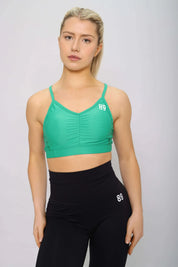 Teal sports bra, padded with removable cups, front view